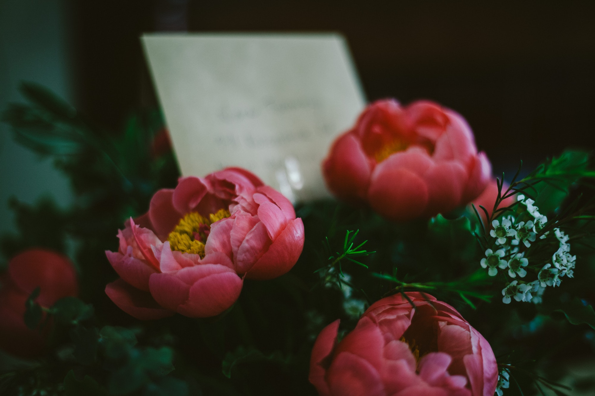 pink flower bouquet with a card at dusk