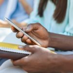 Online Education App. Smartphone In Hands Of Unrecognizable African Male Student