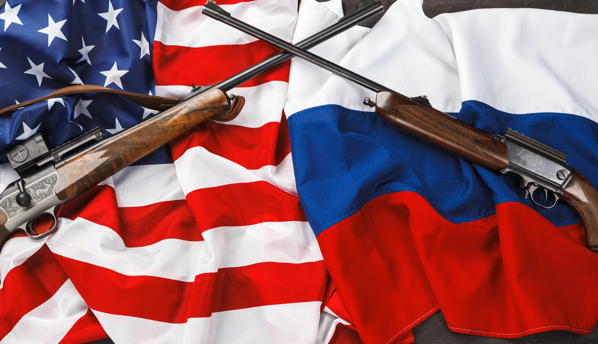 Usa flag and Russia flag background with two crossed shotguns