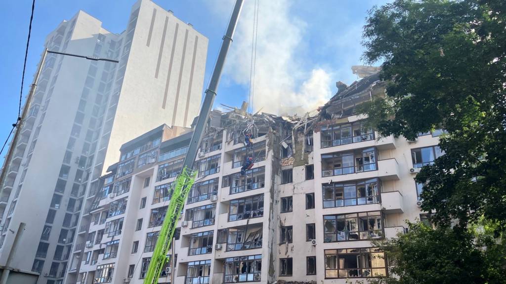 Smoke rises over a residential building damaged by a Russian missile strike, in Kyiv