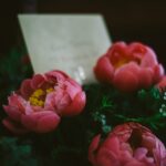pink flower bouquet with a card at dusk