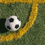 football placed in the corner of a football field