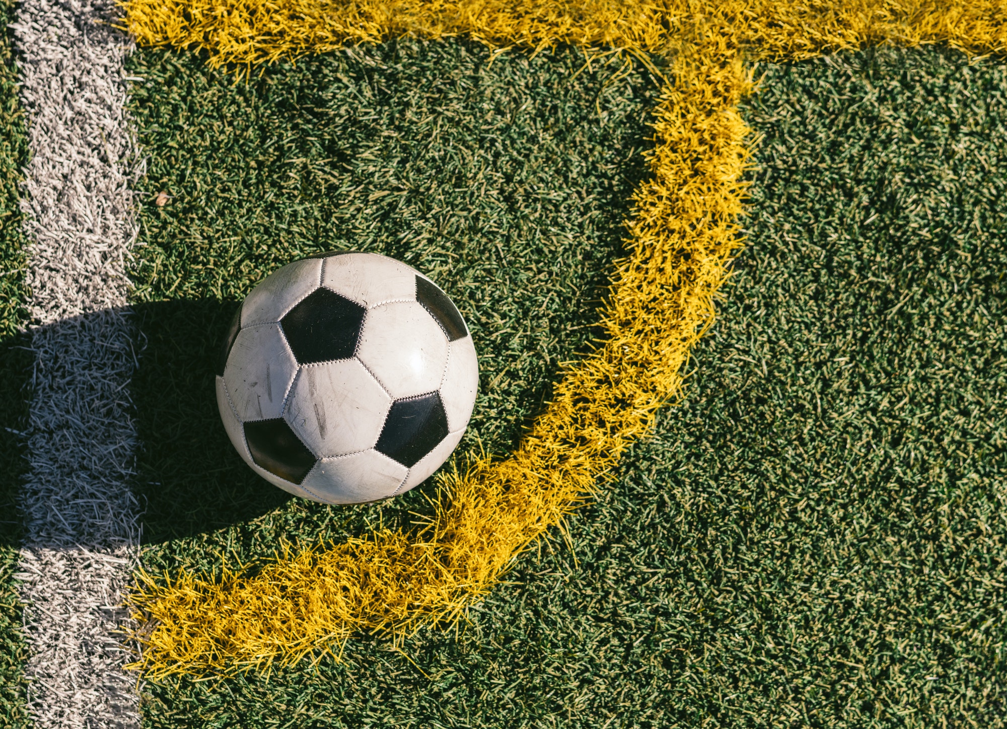 football placed in the corner of a football field