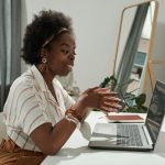 Young African female freelancer communicating in video chat