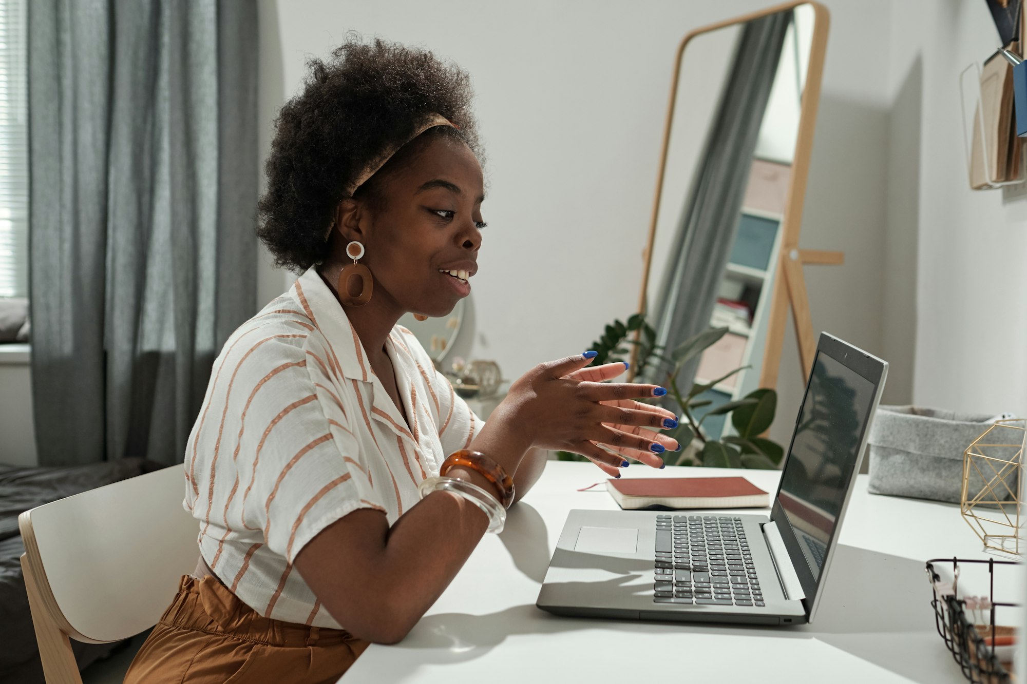 Young African female freelancer communicating in video chat