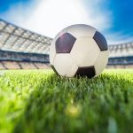 close up view of soccer ball on grass on soccer field stadium