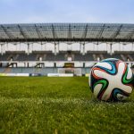 soccer ball on grass field during daytime
