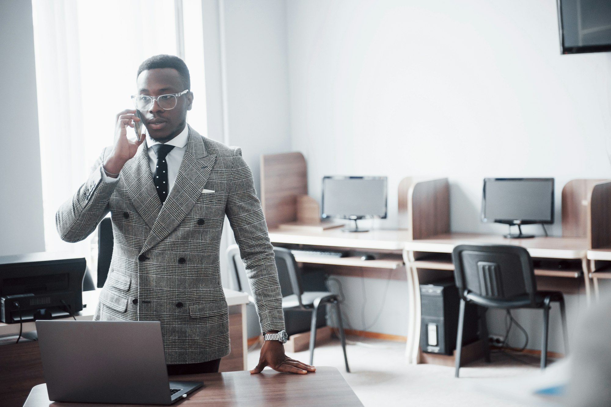 heerful african businessman standing in front of colleague