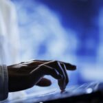 Technician writes AI code on laptop