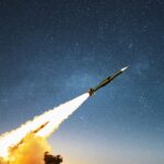 Nuclear missile with smoke and blast launching towards the target on the starry sky