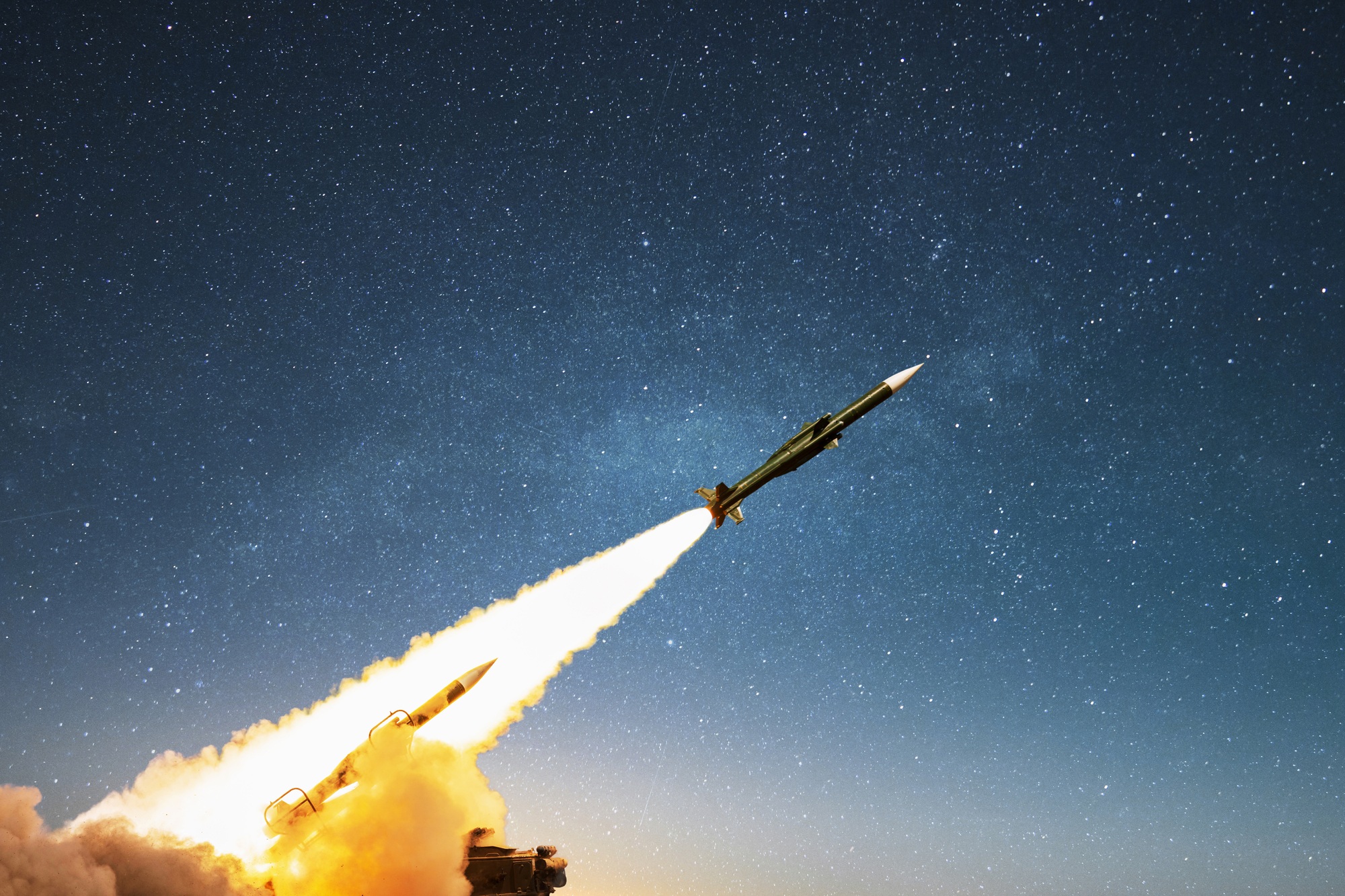 Nuclear missile with smoke and blast launching towards the target on the starry sky